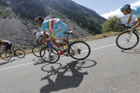 Spain's Alejandro Valverde, Colombia's Nairo Quintana, wearing the best young rider's white jersey, Italy's Vincenzo Nibali and Italy's Michele Scarponi, from left to right, speed downhill during the twentieth stage of the Tour de France cycling race over 110.5 kilometers (68.7 miles) with start in Modane and finish in Alpe d'Huez, France, Saturday, July 25, 2015. (AP Photo/Christophe Ena)