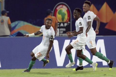 Ivory Coast's Die Serey, left, celebrates with teammates after scoring his side's second goal during the African Cup of Nations group D soccer match between Namibia and Ivory Coast in 30 June Stadium in Cairo, Egypt, Monday, July 1, 2019. (AP Photo/Hassan Ammar)