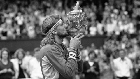 Swedens Bjorn Borg kisses his trophy, after defeating John McEnroe in the final of the Mens Singles Championship at Wimbledon in England, July 5, 1980. Borg defeated McEnroe 1-6; 6-3; 7-5; 6-7; 8-6, to take the All England Lawn Tennis Championship for the fifth year in a row. (AP Photo/Bob Dear)