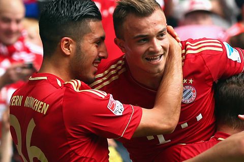 MUNICH, GERMANY - APRIL 27:  Xherdan Shaqiri (C) of Muenchen celebrates scoring the opening goal with his team mates Emre Can (L) and Rafinha (R) during the Bundesliga match between FC Bayern Muenchen and SC Freiburg at Allianz Arena on April 27, 2013 in Munich, Germany.  (Photo by Alexander Hassenstein/Bongarts/Getty Images)