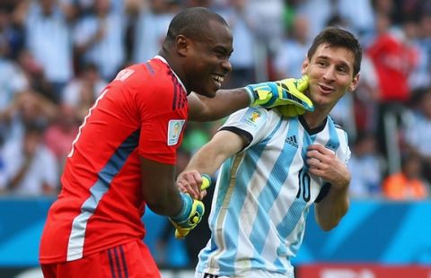 PORTO ALEGRE, BRAZIL - JUNE 25: Goalkeeper Vincent Enyeama of Nigeria shares a joke with Lionel Messi of Argentina during the 2014 FIFA World Cup Brazil Group F match between Nigeria and Argentina at Estadio Beira-Rio on June 25, 2014 in Porto Alegre, Brazil.  (Photo by Jeff Gross/Getty Images)