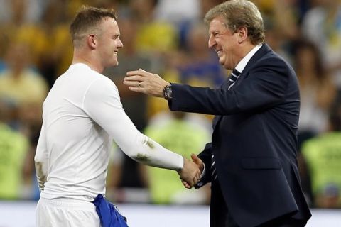 England manager Roy Hodgson, right, celebrates with Wayne Rooney  after  the Euro 2012 soccer championship Group D match between England and Ukraine in Donetsk, Ukraine, Tuesday, June 19, 2012. England won the match, 1-0. (AP Photo/Kirsty Wigglesworth) 