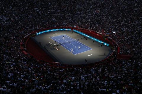 Brothers Bob and Mike Bryan of the U.S., right, take on Mexico's Miguel Angel Reyes Varela and Santiago Gonzalez in an exhibition doubles tennis match in the Plaza de Toros bullring in Mexico City, Saturday, Nov. 23, 2019. Roger Federer of Switzerland and Germany's Alexander Zverev were also to face off in the converted bullring Saturday, the fourth stop in a tour of Latin America by the tennis greats.(AP Photo/Rebecca Blackwell)