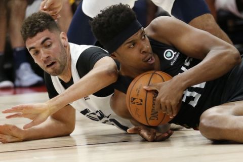 Utah Jazz forward Georges Niang, left, and Atlanta Hawks' Zach LeDay, right, vie for a loose ball during the first half of an NBA summer league basketball game Thursday, July 5, 2018, in Salt Lake City. (AP Photo/Rick Bowmer)