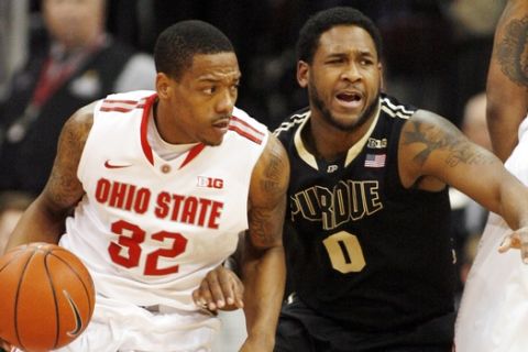 Ohio State's Lenzelle Smith Jr. (32) drives around Purdue's Terone Johnson (0) during the second half of an NCAA college basketball game Saturday, Feb. 8, 2014, in Columbus, Ohio. Ohio Sate won 67-49. (AP Photo/Mike Munden)