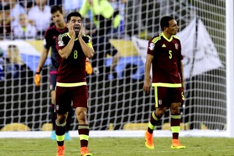 Venezuela's Tomas Rincon (8) and Arquimedes Figuera (5) walk on the pitch after a goal by Argentina during the second half of a Copa America Centenario quarterfinal soccer match on Saturday, June 18, 2016, in Foxborough, Mass. Argentina won 4-1 to advance into a semifinal against host United States. (AP Photo/Charles Krupa)