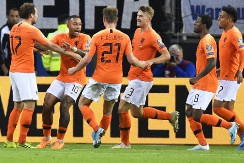 Netherlands players celebrate their side's second goal during the Euro 2020 group C qualifying soccer match between Germany and the Netherlands at the Volksparkstadion in Hamburg, Germany, Friday, Sept. 6, 2019. (AP Photo/Martin Meissner)