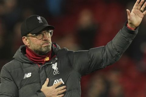 Liverpool's manager Jurgen Klopp applauds fans at the end of the second leg, round of 16, Champions League soccer match between Liverpool and Atletico Madrid at Anfield stadium in Liverpool, England, Wednesday, March 11, 2020. (AP Photo/Jon Super)