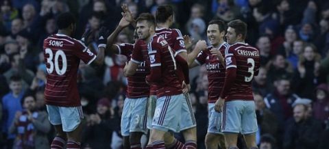 West Ham's Stewart Downing, second right, celebrates with his teammates after scoring his side's third goal during the English Premier League soccer match between West Ham and Hull City at Upton Park stadium in London, Sunday, Jan. 18, 2015.  (AP Photo/Matt Dunham)