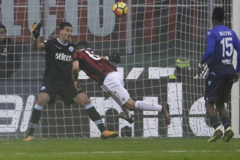 AC Milan's Patrick Cutrone heads the ball past Lazio goalkeeper Thomas Strakosha to score his side's first goal during a Serie A soccer match between AC Milan and Lazio, at the San Siro stadium in Milan, Italy, Sunday, Jan. 28, 2018. (AP Photo/Luca Bruno)