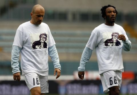 Lazio's Tommaso Rocchi, left, and Thomas Manfredini wear a jersey with a picture of Gabriele Sandri, the Lazio supporter who was shot to death by a police officer, prior to the start of the Italian Top League soccer match beetween Lazio and Parma, at Rome's Olympic  Stadium, Sunday Nov. 25, 2007. (AP Photo/ Alessandra Tarantino)