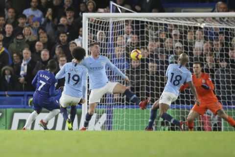 Chelsea's Ngolo Kante, left, scores his side's opening goal during the English Premier League soccer match between Chelsea and Manchester City at Stamford Bridge in London, Saturday Dec. 8, 2018. (AP Photo/Tim Ireland)