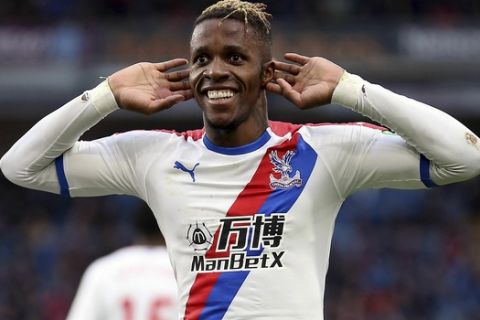 Crystal Palace's Wilfried Zaha celebrates scoring his side's third goal of the game, during the English Premier League soccer match between Burnley and Crystal Palace,  at Turf Moor, in Burnley, England, Saturday, March 2, 2019. (Nigel French/PA via AP)