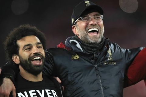 Liverpool's Mohamed Salah, left, and manager Jurgen Klopp celebrate after the Champions League Semi Final, second leg soccer match between Liverpool and Barcelona at Anfield, Liverpool, England, Tuesday, May 7, 2019. Liverpool won the match 4-0 to overturn a three-goal deficit to win 4-3 on aggregate. (Peter Byrne/PA via AP)