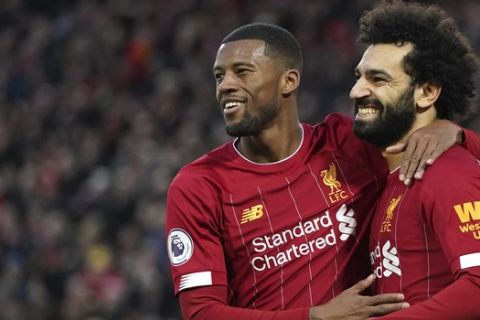 Liverpool's Mohamed Salah, right, celebrates with Liverpool's Georginio Wijnaldum after scoring his sides third goal during the English Premier League soccer match between Liverpool and Southampton at Anfield Stadium, Liverpool, England, Saturday, February 1, 2020. (AP Photo/Jon Super)