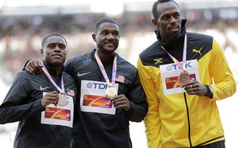 United States' Christian Coleman, silver, Justin Gatlin of the United States, gold, and Jamaica's Usain Bolt, bronze, from left, during the medal ceremony for the Men's 100m during the World Athletics Championships in London Sunday, Aug. 6, 2017. (AP Photo/David J. Phillip)