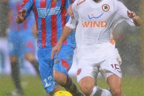 AS Roma midfielder Miralem Pjanic, of Bosnia, right, challenges for the ball with Catania midfielder Mariano Izco, of Argentina, during a Serie A soccer match between Catania and AS Roma at the Angelo Massimino stadium in Catania, Italy, Saturday, Jan. 14, 2012. (AP Photo/Carmelo Imbesi)