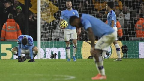 Manchester City' players react after Wolverhampton Wanderers' Matt Doherty scored his side's third goal, during the English Premier League soccer match between Wolverhampton Wanderers and Manchester City at the Molineux Stadium in Wolverhampton, England, Friday, Dec. 27, 2019. (AP Photo/Rui Vieira)
