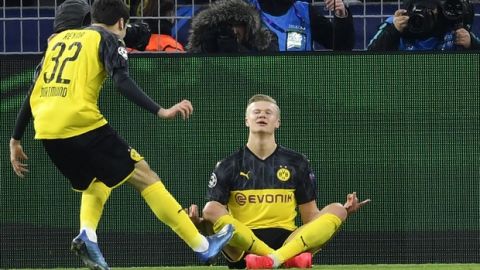 Dortmund's Erling Braut Haaland, right, celebrates after scoring the opening goal during the Champions League round of 16 first leg soccer match between Borussia Dortmund and Paris Saint Germain in Dortmund, Germany, Tuesday, Feb. 18, 2020. (AP Photo/Martin Meissner)