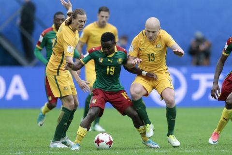 Australia's Aaron Mooy, right, challenges Cameroon's Collins Fai during the Confederations Cup, Group B soccer match between Cameroon and Australia, at the St. Petersburg Stadium, Russia, Thursday, June 22, 2017. (AP Photo/Ivan Sekretarev)