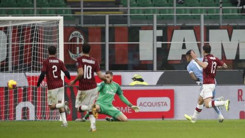 Lazio's Joaquin Correa, second right, scores his side's second goal during the Serie A soccer match between AC Milan and Lazio at the San Siro stadium, in Milan, Italy, Sunday, Nov. 3, 2019, (AP Photo/Antonio Calanni)
