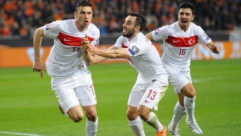 Turkey's Forward Burak Yilmaz (L) celebrates with teammates after scoring during the Euro 2016 qualifying round football match between Netherlands and Turkey at the Arena Stadium, on March 27, 2015 in Amsterdam. AFP PHOTO / JOHN THYS        (Photo credit should read JOHN THYS/AFP/Getty Images)