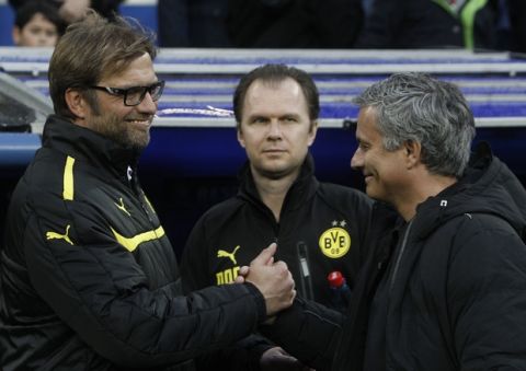 Dortmund head coach Juergen Klopp, left, shakes hands with Madrid coach Jose Mourinho from Portugal, prior to the Champions League semifinal second leg soccer match between Real Madrid and Borussia Dortmund at the Santiago Bernabeu stadium in Madrid, Spain, Tuesday April 30, 2013. (AP Photo/Alberto Di Lolli)