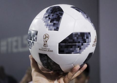 Argentinian national soccer team striker Lionel Messi shows the official match ball for the 2018 FIFA World Cup Russia, named Telstar 18 , during the unveiling ceremony in Moscow, Russia, Thursday, Nov. 9, 2017. The Telstar 18 has a retro black-and-white design harking back to the original Adidas Telstar ball used for the 1970 World Cup and Adidas says that in terms of structure, it's an evolution of the ball used for the last World Cup in 2014. (Oleg Shalmer)