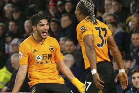 Wolverhampton Wanderers' Raul Jimenez, left,  celebrates scoring his side's second goal of the game with Adama Traoreduring the English Premier League soccer match between Bournemouth and Wolverhampton Wanderers, at the Vitality Stadium, in Bournemouth, England, Saturday, Nov. 23, 2019. (Mark Kerton/PA via AP)