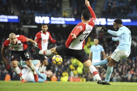Manchester City's Raheem Sterling, right, scores his side second goal during the English Premier League soccer match between Manchester City and Southampton at Etihad stadium, in Manchester, England, Wednesday, Nov. 29, 2017. (AP Photo/Rui Vieira)