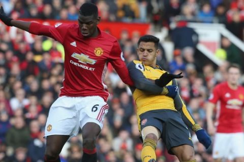 MANCHESTER, ENGLAND - NOVEMBER 19:  Paul Pogba of Manchester United in action with Alexis Sanchez of Arsenal during the Premier League match between Manchester United and Arsenal at Old Trafford on November 19, 2016 in Manchester, England.  (Photo by Tom Purslow/Man Utd via Getty Images)