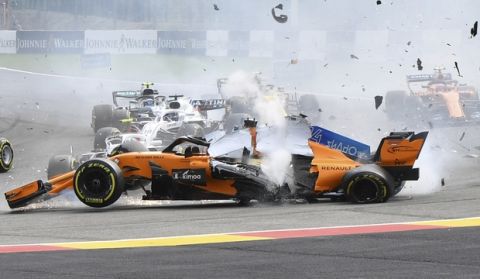 Mclaren driver Fernando Alonso of Spain, center, crashes at the start of the Belgian Formula One Grand Prix in Spa-Francorchamps, Belgium, Sunday, Aug. 26, 2018. (AP Photo/Geert Vanden Wijngaert)