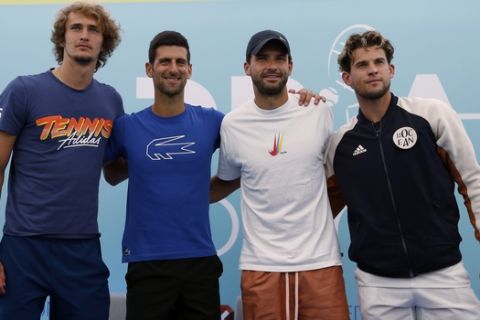 Serbia's Novak Djokovic, second left, poses with Germany's Alexander Zverev, left, Bulgaria's Grigor Dimitrov, second right, and Austria's Dominic Thiem after a press conference prior a a charity tournament Adria Tour, in Belgrade, Serbia, Friday June 12, 2020. Serbian tennis player Novak Djokovic set up a series of tennis tournaments in the Balkan region while the sport is suspended amid the coronavirus pandemic. (AP Photo/Darko Vojinovic)