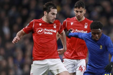 Chelsea's Tariq Lamptey vies for the ball with Nottingham Forest's Yuri Ribeiro, left, and Tyrese Fornah, right, during an English FA Cup third round soccer match between Chelsea and Nottingham Forest at Stamford Bridge in London, Sunday, Jan. 5, 2020. (AP Photo/Ian Walton)