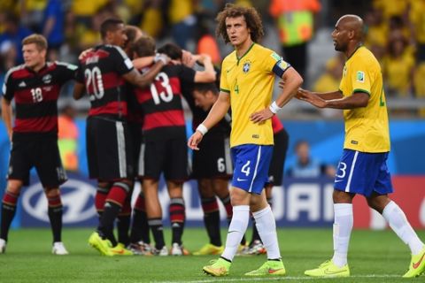 BELO HORIZONTE, BRAZIL - JULY 08:  David Luiz and Maicon of Brazil react after allowing a goal during the 2014 FIFA World Cup Brazil Semi Final match between Brazil and Germany at Estadio Mineirao on July 8, 2014 in Belo Horizonte, Brazil.  (Photo by Laurence Griffiths/Getty Images)