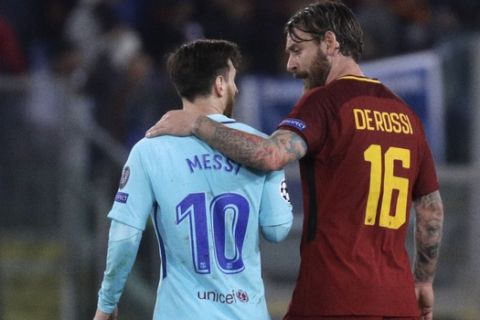 Barcelona's Lionel Messi, left, and Roma's Daniele De Rossi talk as they walk off the pitch during half time in the Champions League quarterfinal second leg soccer match between between Roma and FC Barcelona, at Rome's Olympic Stadium, Tuesday, April 10, 2018. (AP Photo/Gregorio Borgia)