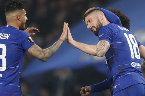 Chelsea's Emerson Palmieri, left, high-fives with Chelsea's Oliver Giroud, right, who scored his side's first goal during the round of 32, second leg, Europa League soccer match between Chelsea and Malmo FF at Stamford Bridge stadium in London, Thursday Feb. 21, 2019. (AP Photo/Frank Augstein)