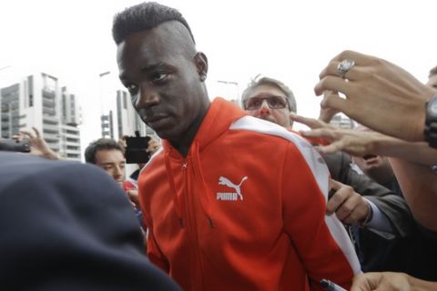 Italian soccer forward Mario Balotelli arrives at AC Milan headquarters, in Milan, Italy, Tuesday, Aug. 25, 2015. AC Milan's vice president Adriano Galliani said the club is in talks with Liverpool about bringing striker Mario Balotelli back to Serie A. (AP Photo/Luca Bruno)