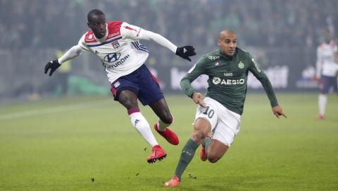 Lyon's Ferland Mendy, left, challenges for the ball with Saint-Etienne's Wahbi Khazri, right, during their French League One soccer match in Saint-Etienne, central France, Sunday, Jan. 20, 2019. (AP Photo/Laurent Cipriani)