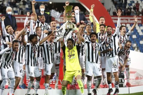 Juventus players celebrate with the winner's trophy their victory against Atalanta after the end of Italian Cup soccer final match between Atalanta and Juventus at the Mapei Stadium in Reggio Emilia, Italy, Wednesday, May 19, 2021. Juventus win Atalanta 2-1. (AP Photo/Antonio Calanni)
