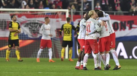 Salzburg's players celebrate after the Europa League - round of 16 second leg soccer match between FC Salzburg and Borussia Dortmund in the Arena in Salzburg, Austria, on Thursday, March 15, 2018. The match finished 0-0. (AP Photo/Kerstin Joensson)