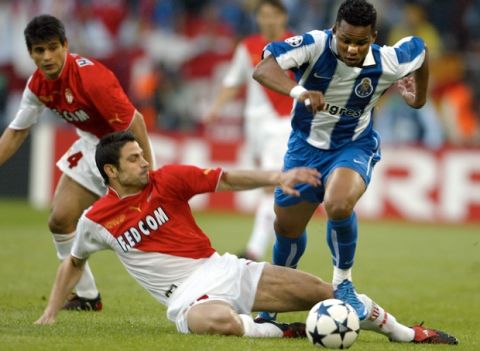 Andreas Zikos of Monaco, left, challenges Carlos Alberto of Porto during the UEFA Champions League Final between AS Monaco and  FC Porto in the 'Arena AufSchalke' in Gelsenkirchen, Germany, Wednesday, May 26, 2004. (AP Photo/Frank Augstein)