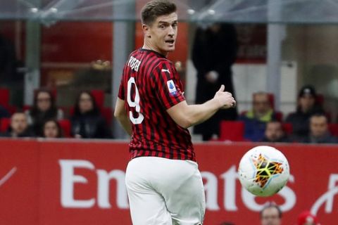 AC Milan's Krzysztof Piatek looks the ball during the Serie A soccer match between AC Milan and Spal at the San Siro stadium, in Milan, Italy, Thursday, Oct. 31, 2019. (AP Photo/Antonio Calanni)