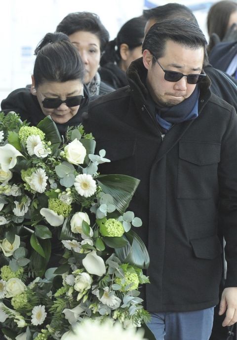 Aiyawatt Srivaddhanaprabha, the son of Vichai Srivaddhanaprabha, and his mother Aimon, left, lay a wreath with family members outside Leicester City Football Club, Leicester, England, Monday Oct. 29, 2018, after a helicopter crashed in flames Saturday. Vichai Srivaddhanaprabha, the Thai billionaire owner of Premier League team Leicester City was among five people who died after his helicopter crashed and burst into flames shortly after taking off from the soccer field, the club said Sunday. (AP Photo/Rui Vieira)