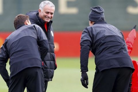 Manchester United manager Jose Mourinho speaks with Nemanja Matic, left, and Zlatan Ibrahimovich, right, during a training session at the AON Training Complex, Carrington, England, Tuesday Nov. 21, 2017. (Martin Rickett/PA via AP)