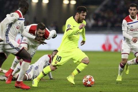 Barcelona forward Lionel Messi, 2nd right, controls the ball during the Champions League round of 16 first leg soccer match between Lyon and FC Barcelona in Decines, near Lyon, central France, Tuesday, Feb. 19, 2019. (AP Photo/Laurent Cipriani)