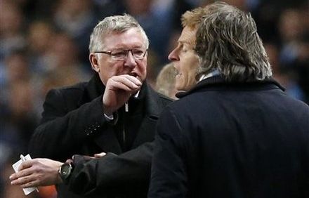 Manchester United's manager Sir Alex Ferguson, left, gestures towards Manchester City's manager Roberto Mancini, right, as an official comes between them during the English Premier League soccer match between Manchester City and Manchester United at the Etihad Stadium in Manchester, Monday, April 30, 2012.  (AP Photo/Matt Dunham) 