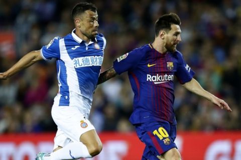 FC Barcelona's Lionel Messi, right, duels for the ball against Espanyol's Javi Fuego during the Spanish La Liga soccer match between FC Barcelona and Espanyol at the Camp Nou stadium in Barcelona, Spain, Saturday, Sept. 9, 2017. (AP Photo/Manu Fernandez)