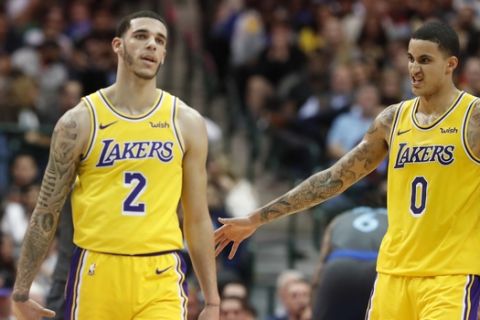 Los Angeles Lakers guard Lonzo Ball (2) and forward Kyle Kuzma (0) during the second half of an NBA basketball game against the Dallas Mavericks in Dallas, Monday, Jan. 7, 2019. (AP Photo/LM Otero)