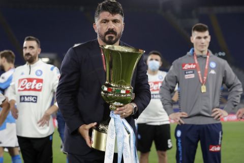 Napoli's head coach Gennaro Gattuso holds the Italian Cup trophy at the end of the final match between Napoli and Juventus, at Rome's Olympic Stadium, Wednesday, June 17, 2020. (AP Photo/Andrew Medichini)